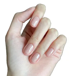Glossy nude pink press-on nails with cat and bow hand-painted patterns in round oval shape