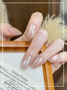 Detailed view of aurora pearlescent almond-shaped press-on nails with glossy pink finish