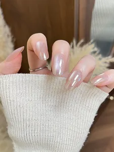 Close-up of elegant pale pink cat eye press-on nails with a soft pearl aurora finish