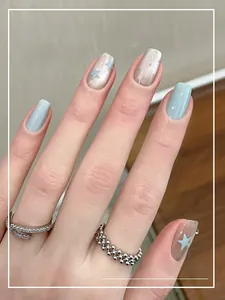 Short blue cat eye press-on nails with silver star patterns and glossy finish