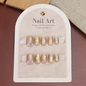 Champagne cat eye press-on nails with colorful star patterns and glass bead finish