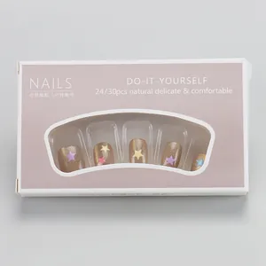Detail of glitter press-on nails with star patterns in purple window packaging