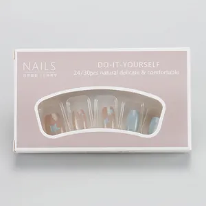 Front view of pink packaging box for DIY press-on nails with blue star pattern design