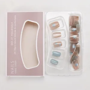 Short matte press-on nails in cream coffee and grey-blue with blue star patterns