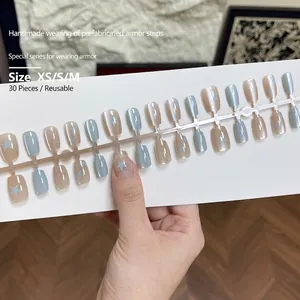 Short blue and pink cat eye press-on nails set with minimalist star and dot designs