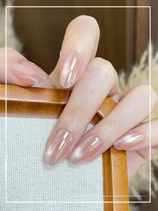 Macro detail of nude pink cat-eye gradient press-on nails with a pearlescent finish