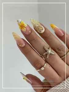 Detail of 3D lemon and floral charms on almond shaped press-on nails with yellow finish