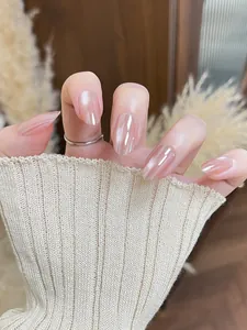 Close-up of pink cat-eye almond nails with glossy mirror finish and a silver ring