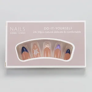 Detail of French press-on nail kit with blue stars and purple box packaging