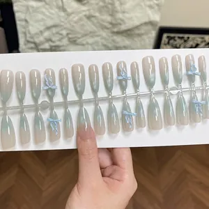 Blue glass bead gradient press-on nails with bow designs in a long almond shape