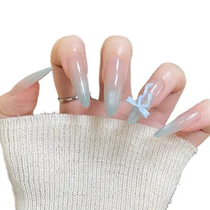 Light blue cat eye gradient press-on nails with 3D bow design in long stiletto shape