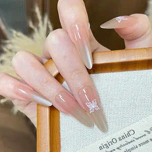 Elegant long stiletto press-on nails with nude pink gradient and cat-eye butterfly design