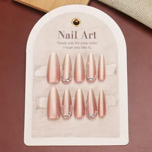 Elegant almond gradient press-on nails in nude pink with rhinestones and bead accents