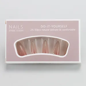 Detail of pink gradient press-on nails with rhinestones in a transparent window box