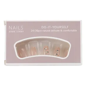 Short press-on nails set with glitter and pearls in pink display box packaging