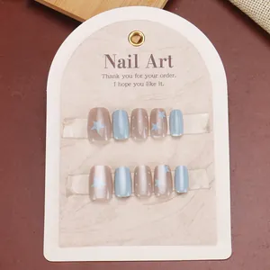 Close-up of light blue star and dot press-on nails with cat eye shimmer finish
