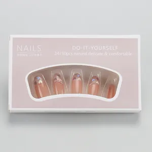 Pink French press-on nails with heart accents in a Morandi pink display box