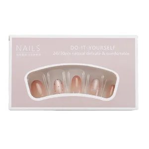 Pink gradient press-on nails with bow and polka dot patterns in a white window box