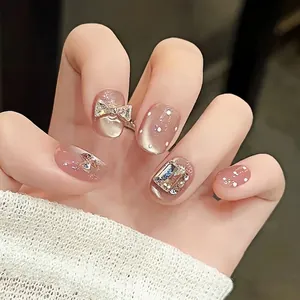 Faux ongles fait main rose nude œil de chat avec nœud 3D et cristaux brillants