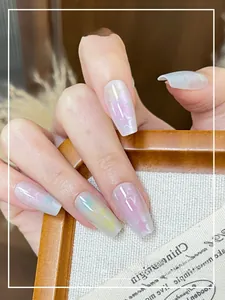 Detailed view of coffin-shaped press-on nails with colorful macaron stars and pearly finish