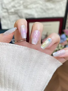 Detailed view of macaron gradient press-on nails with cat-eye glitter and star patterns