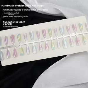 Detail of macaron gradient press-on nails with star patterns on silk fabric