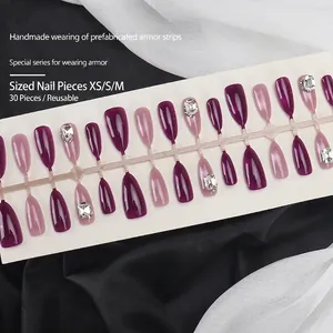 Purple and pink gradient cat-eye press-on nails with gemstone accents on display card