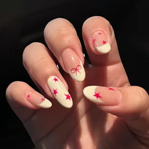 French almond press-on nails featuring red stars and elegant bow designs on a nude base