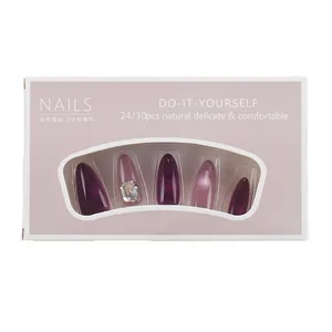 Purple and pink cat-eye press-on nails set in almond shape with square rhinestone accents