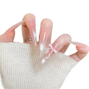 Pink gradient cat-eye stiletto press-on nails with 3D white bow and pearl finish