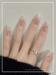Close-up of nude pink gradient press-on nails with fine shimmer and glossy finish