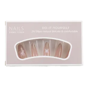 Long pointed French style press-on nails in nude pink with white butterfly patterns