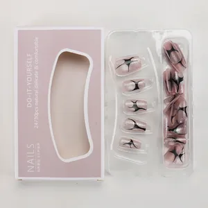 Close-up of pink glitter press-on nails with black punk star patterns in packaging