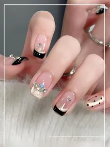 Close-up of handmade press-on nails with French black tips and glitter accents