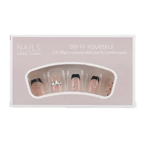 Cat eye press-on nails set with black gold French diamond designs and polka dots
