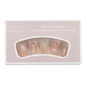 Press-on nail set in nude pink with pearls, rhinestones, and 3D bows in a pink gift box