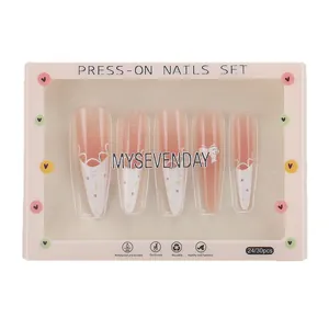 Pink gradient press-on nails with white wave patterns and purple dots in box