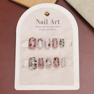 Short press-on nails set with leopard print and star designs in warm coffee and beige tones