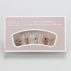 Detailed view of leopard print and heart pattern press-on nails in a purple DIY gift box