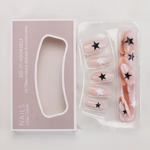 Detail of nude pink star press-on nails set with 3D pearls and branded packaging