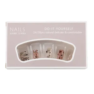 Short leopard print and star pattern press-on nails in elegant retail packaging