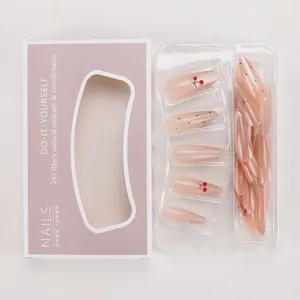 Detail of pink gradient press-on nails with cherry patterns in a lilac display gift box