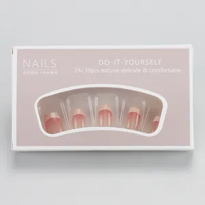 Detail view of pink gradient press-on nails with fine glitter and French nude tips in box