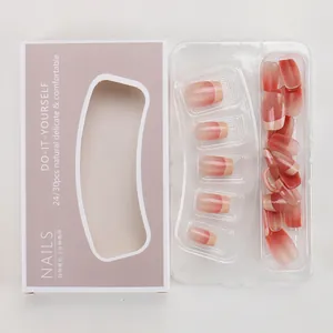 Detail of pink gradient press-on nails with fine glitter in elegant paper packaging