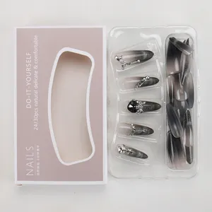Detail of silver-black gradient cat-eye press-on nails with rhinestones and bows
