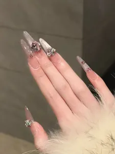 Detailed view of luxury press-on nails with silver glitter gradient and 3D rhinestones