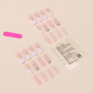 Detail view of 24pcs pink Christmas nails with glitter snowflakes and stripes