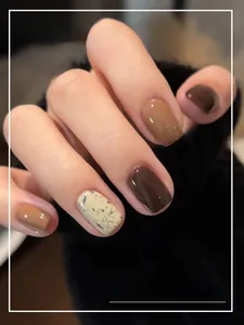 Short square press-on nails with dark brown, khaki, and stone pattern marble finish