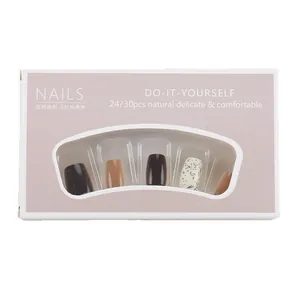 Short press-on nail kit in brown and creamy white with ink splatter dots on 24pcs false nails