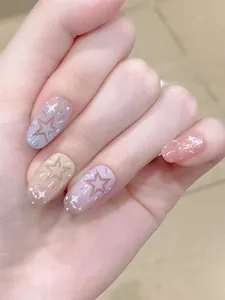 Macro detail of macaron gradient star nails with glitter on oval press-on nails